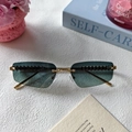 Green gradient rimless sunglasses with gold metal rivet temples on marble surface - Green