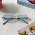 Rimless gold sunglasses with light blue lenses and leopard head metal hinge detail - Blue