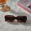 Detailed close-up of retro square tortoiseshell sunglasses with brown tinted lenses - Leopard Print