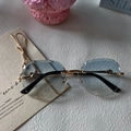 Fashionable rimless oval sunglasses with blue gradient lenses and gold metal frame - Blue