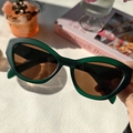 Gros plan de lunettes de soleil œil de chat rétro avec monture vert mat et verres bruns - Vert