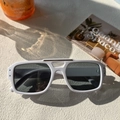 White double-bridge square sunglasses with dark lenses on a textured cream surface - White