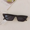 Vintage black cat eye sunglasses with glossy frame and dark lenses on creative background - Black and Gray