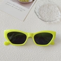 Neon green cat-eye sunglasses with thick glossy frames and dark grey lenses for Y2K style - Neon Yellow