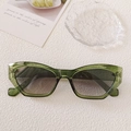 Retro cat-eye sunglasses featuring a translucent green frame and dark grey gradient lenses - Transparent Green