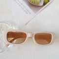 Retro rectangular sunglasses with cream frames and tea lenses on a decorative background - Off White