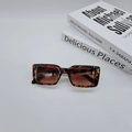 Detail shot of vintage rectangle tortoiseshell sunglasses with brown lenses on white background - Leopard Print