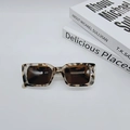 Detail of vintage rectangle sunglasses featuring tortoiseshell texture and dark lenses - Leopard Frame White Tea Lens