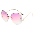 Chique randloze vlinderzonnebril met roze-paars verloop en luxe strass-accenten - Gouden Montuur Paars Roze Lens