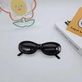Retro all-black oval sunglasses featuring a glossy frame and dark lenses for a 90s vibe - Black