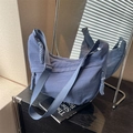 Blue-purple nylon dumpling crossbody bag with woven zipper pulls and adjustable strap - Blue
