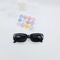 Detailed view of black rectangle kids sunglasses with glossy frames and UV lenses - Black