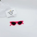 Detail view of pink cat-eye sunglasses for kids with dark lenses and retro plastic frame - Rose Red