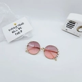 Detail of round gold metal kids sunglasses with pearl inlay and pink gradient lenses - Dusty Pink