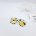 Macro detail of yellow lenses and transparent double-frame design on stylish kids sunglasses - Black Frame Yellow Lens