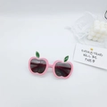 Detail of pink apple-shaped kids sunglasses with green leaf accents on white background - Pink