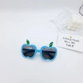 Detailed view of blue apple-shaped kids sunglasses with green leaf accents on frames - Blue