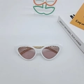 White cat-eye sunglasses with light pink lenses and decorative gold chain on the frame - White Frame Champagne