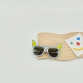 Detail of cartoon bulldog kids sunglasses on a minimalist wooden tray accessory - Gray