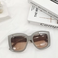 Flat lay of vintage square frame sunglasses with gradient brown lenses on white textured fabric - Gray