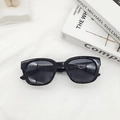 Flat lay of black square frame sunglasses on white textured fabric background - Bright Black
