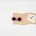 Detailed view of lavender cartoon parrot sunglasses for kids with UV protection - Purple