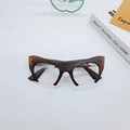 Dark brown cat-eye half-frame glasses with matte finish shown on a white desk - Dark Tea