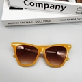 Detailed top view of bright orange sunglasses with metal stud accents on the frame - Jelly Yellow