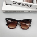 Macro detail of cat-eye sunglasses with tortoiseshell accents and silver decorative studs - Black and Leopard Print