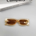 Detail of champagne gold square sunglasses with brown lenses and golden B-letter decoration - Champagne