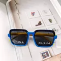 Detailed view of kids square sunglasses with contrast frame and yellow temples - Blue