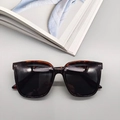 Close-up of tortoise shell square frame sunglasses with metal rivet details - Leopard Print