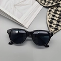Flat lay of retro oversized black sunglasses with metal stud details on grey background - Bright Black