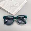 Chic dark green thick frame oval sunglasses with grey lenses on a lifestyle magazine - Dark Green