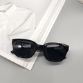 Classic black square frame sunglasses with dark lenses on a minimalist background - Bright Black