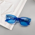 Chic blue transparent square sunglasses with retro frame for women on gray background - Transparent Blue