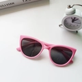 Detail of pink cat-eye children's sunglasses with dark lenses on a white background - Pink