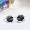 Detail of round cream baby sunglasses with UV protection and smooth thick frames - White