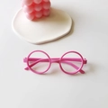 Pink round frame glasses for kids with glossy plastic finish shown on a white tabletop - Pink