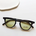 Retro round black kids sunglasses with light yellow-green lenses and UV400 protection - Black Frame Green Lens