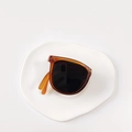 Foldable children's sunglasses featuring amber frames and dark UV protection lenses - Milk Tea