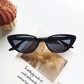 Kids black cat-eye sunglasses with UV400 protection on vintage book background - Black