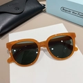 Detailed view of amber tortoise sunglasses with dark lenses and luxury leather case - Amber Orange Frame Dark Green Lens