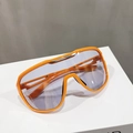 Detail of oversized orange sports sunglasses with light blue lenses and gold trim accent - Orange