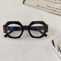 Close-up of geometric round sunglasses with tortoiseshell accents and model dimensions - Black Frame Clear Lenses