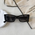 Detail view of black rectangular sunglasses with size markings on white textured surface - Black and Gray