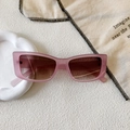 Macro detail of retro rectangular sunglasses with translucent pink frame and gradient lenses - Transparent Pink