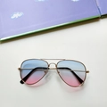 Close-up of kids aviator sunglasses featuring blue pink gradient lenses and gold metal frames - Blue Pink