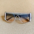 Detail of oversized shield sunglasses with crystal rhinestones and iridescent gem accents - Blue Pink
