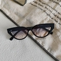 Detail shot of vintage black cat-eye sunglasses with gradient lenses and a sleek finish - Black Frame Blue-Tea Gradient Lens